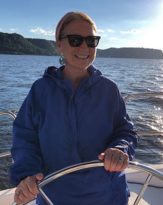 Gretchen Stein Driving A Boat And Smiling